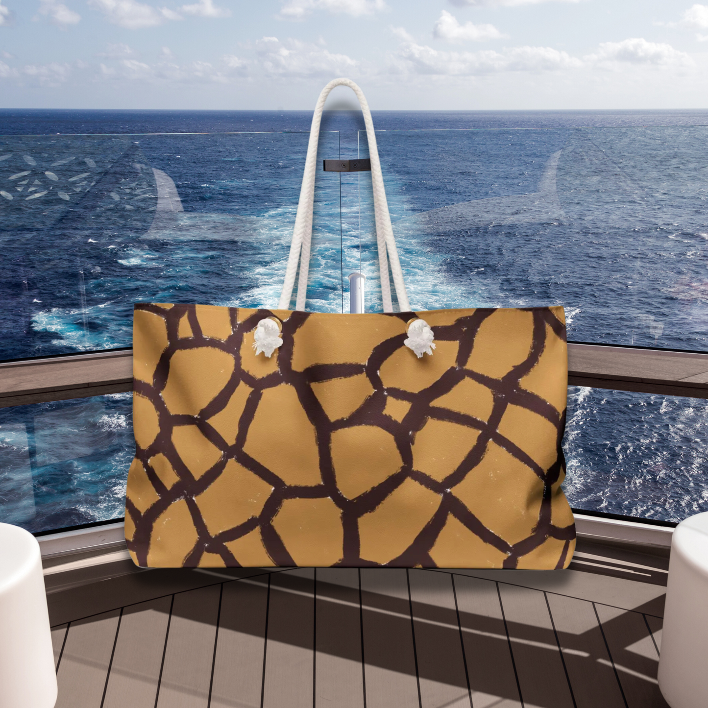 Oversized animal print travel tote with gold-tone grommets and durable T-bottom, perfect for stylish weekend escapes.
