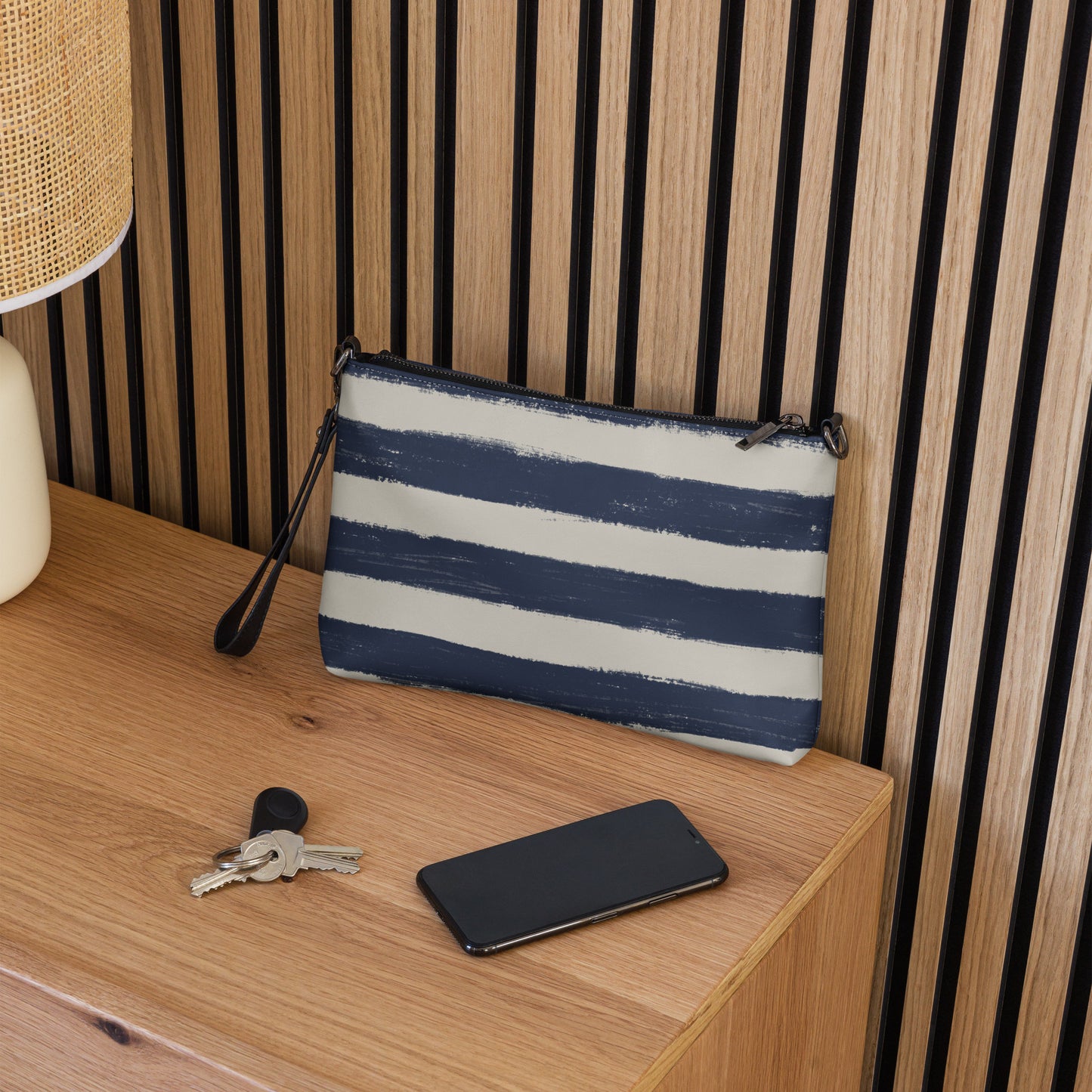 Striped crossbody purse styled on modern wooden nightstand, perfect for everyday or travel essentials