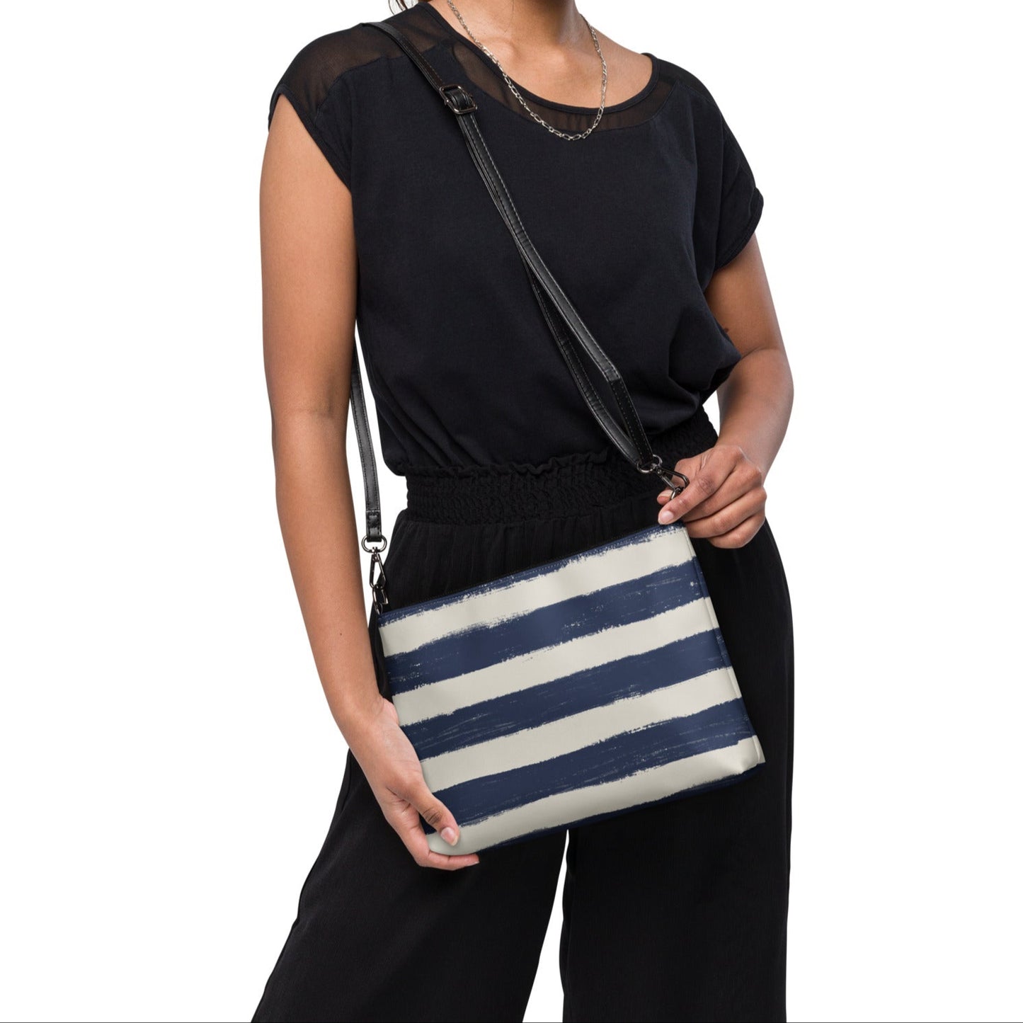 Woman wearing Breton stripe vegan crossbody bag styled with black outfit, perfect for casual days