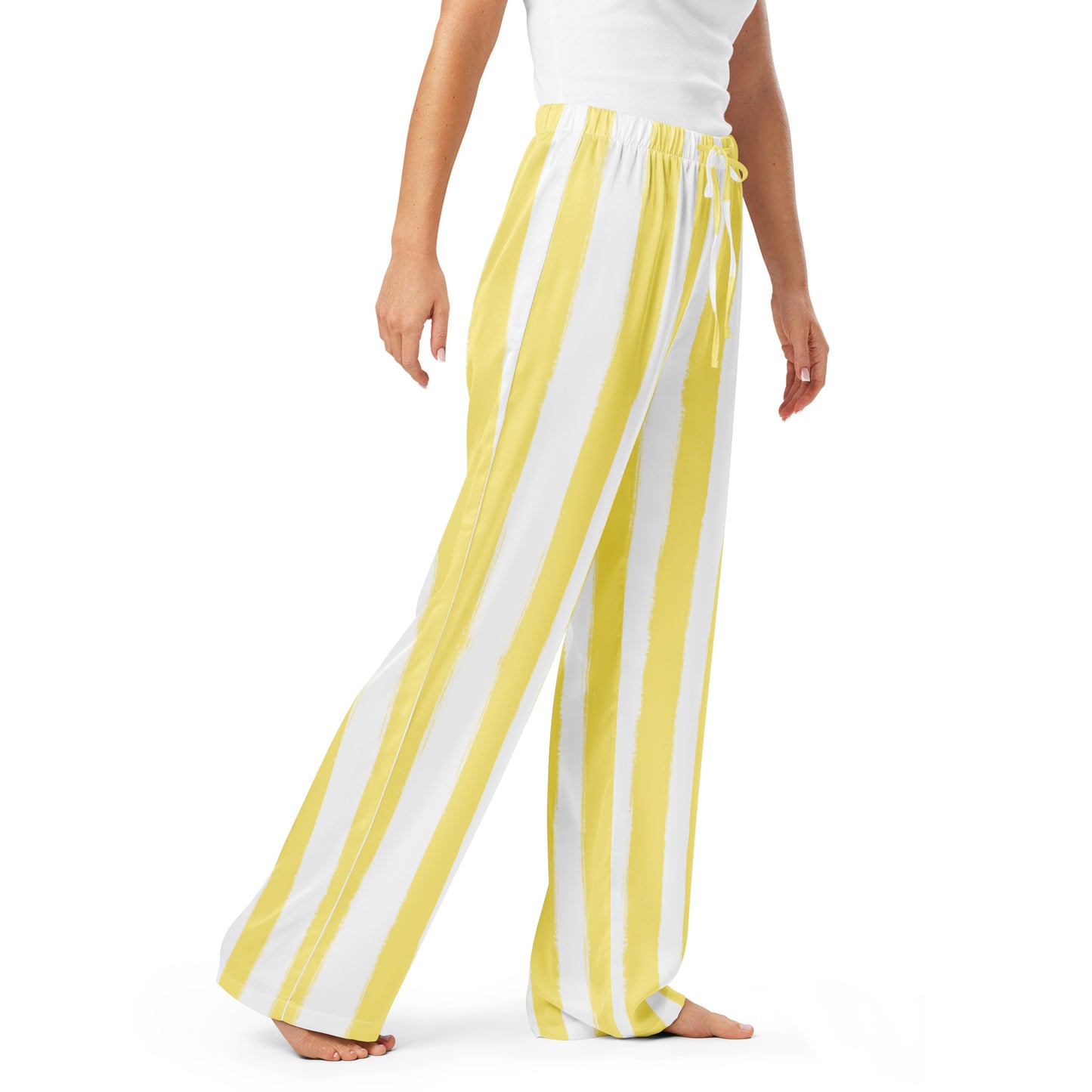 Model in butter yellow striped pajama pants paired with white tee, perfect for effortless everyday loungewear or travel outfits.