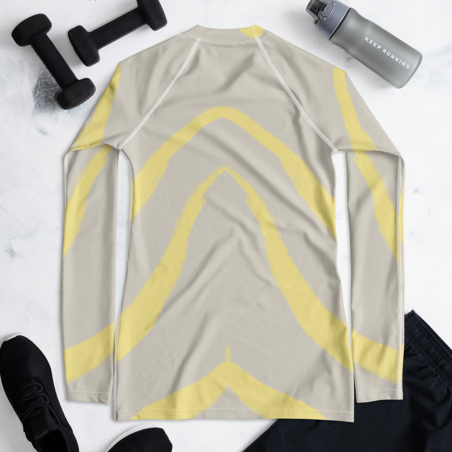 Flat lay of Panther & Palm women’s butter yellow rash guard with UPF 50+ protection and soft spandex-poly blend, perfect for active days.