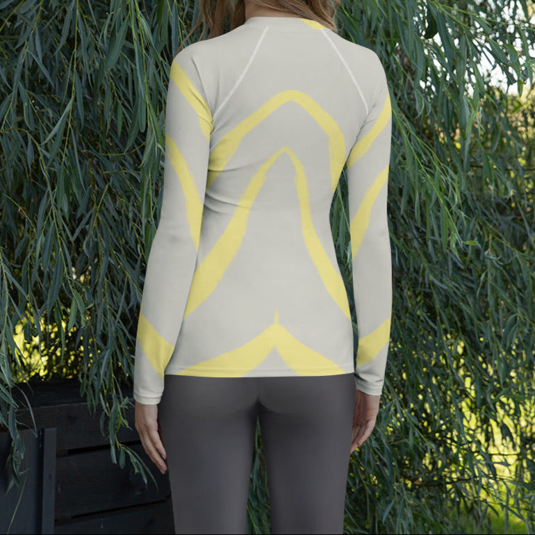 Panther & Palm women’s rash guard in butter yellow and beige worn outdoors, ideal for layering, outdoor workouts, or sun-safe travel wear.