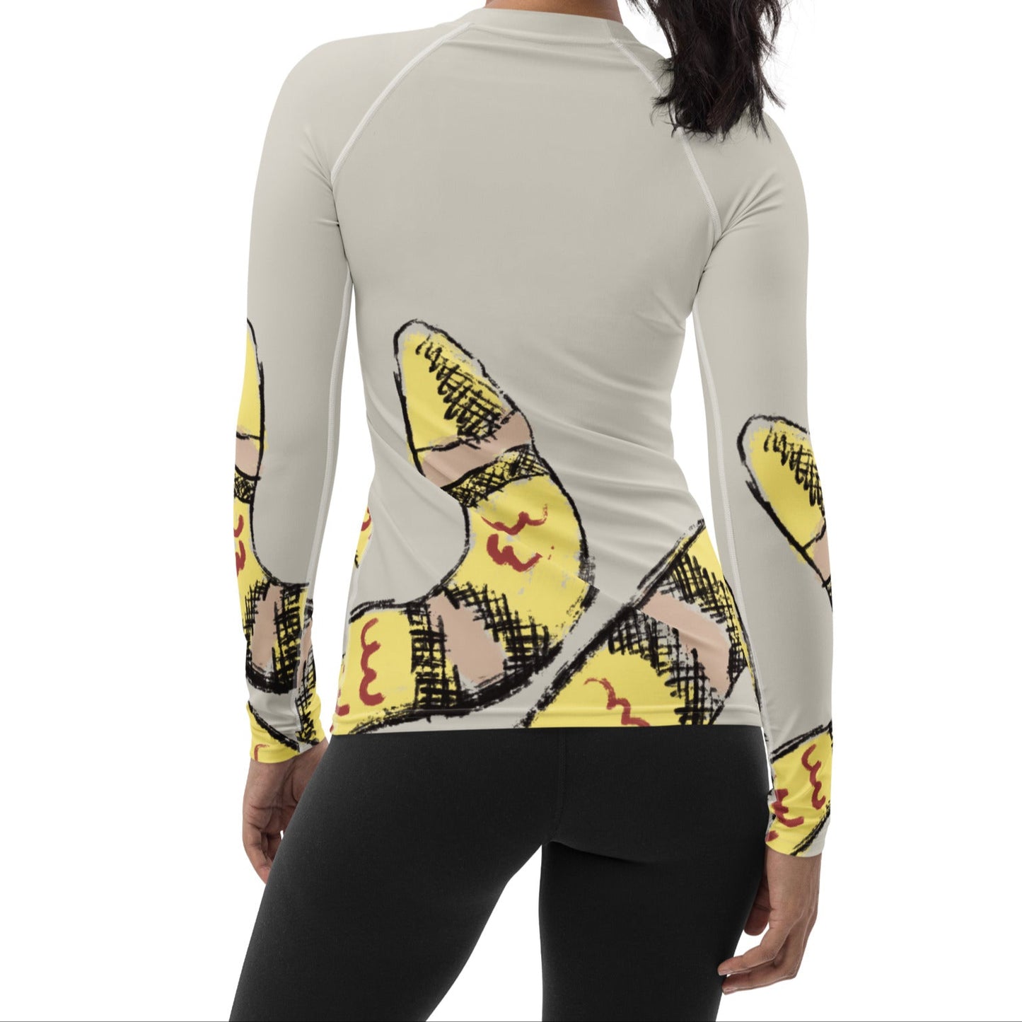 Woman wearing yellow snake print long-sleeve rash guard by Panther & Palm, showcasing UPF 50+ activewear with ergonomic fit.