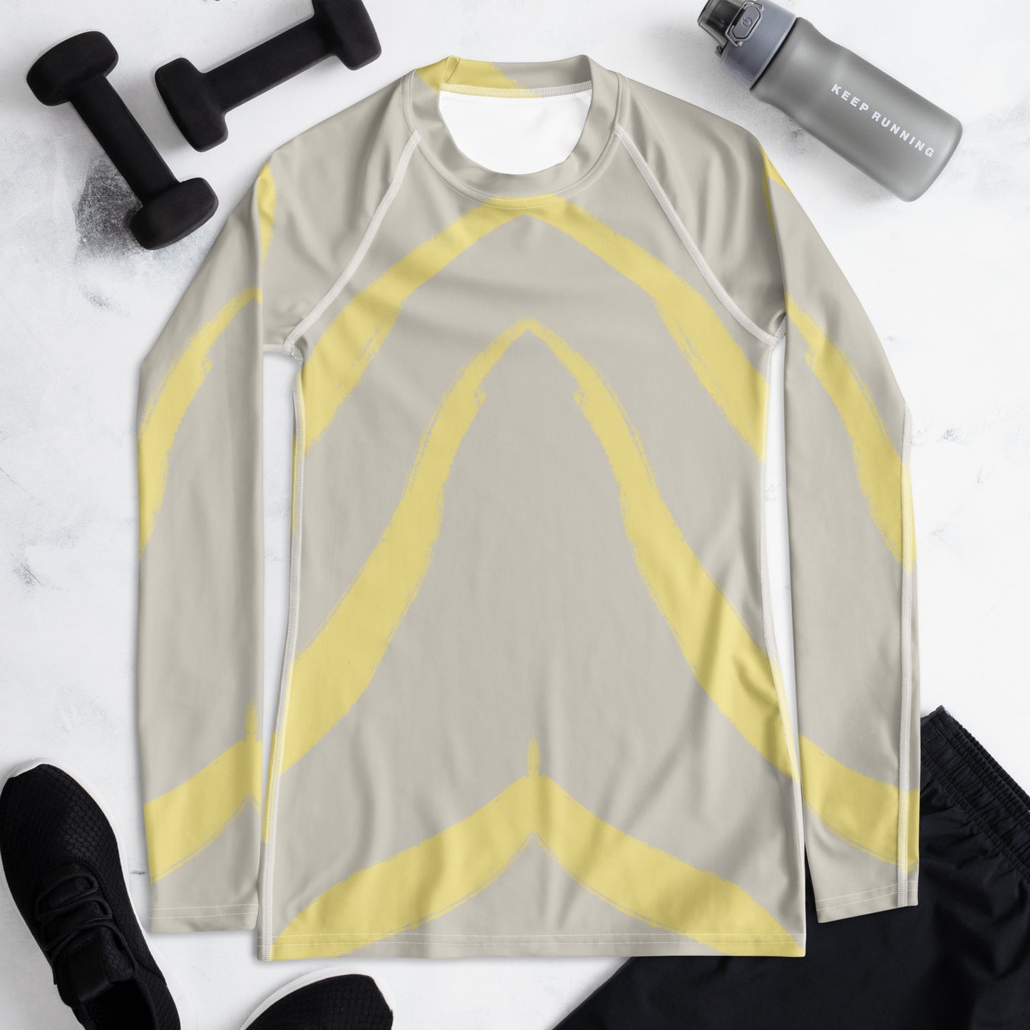 Flat lay of Panther & Palm women’s rash guard in butter yellow and beige, styled with fitness gear to highlight performance and travel versatility.