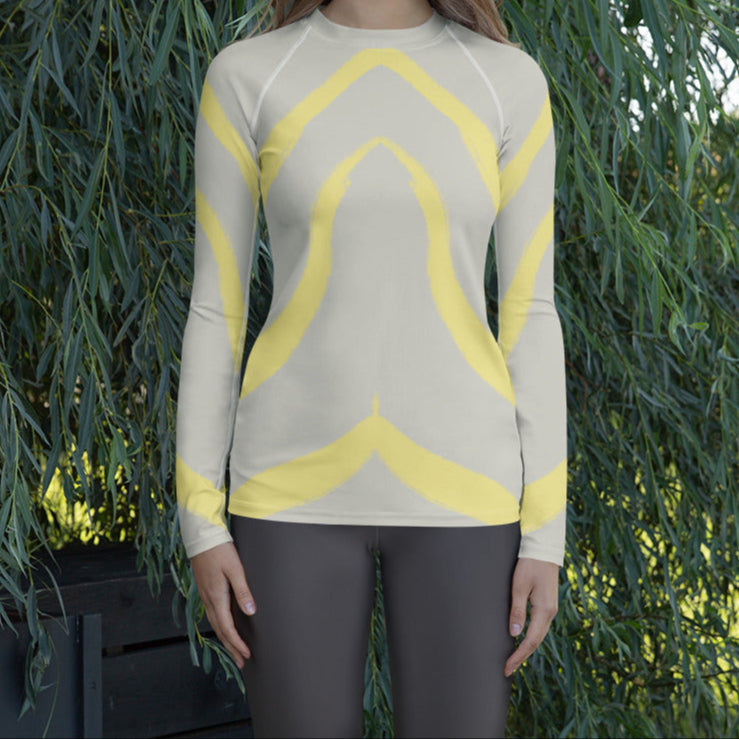 Panther & Palm women’s rash guard in butter yellow and beige worn outdoors, ideal for layering, outdoor workouts, or sun-safe travel wear.