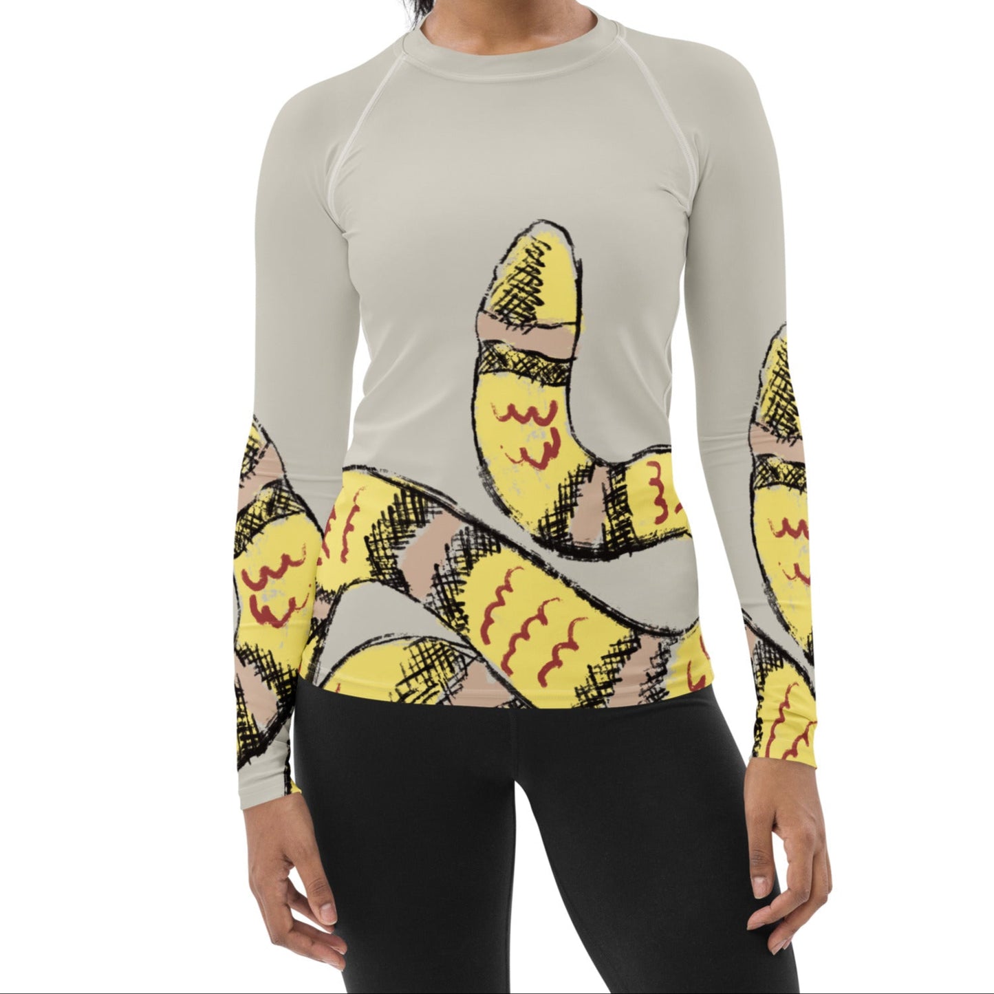 Woman wearing yellow snake print long-sleeve rash guard by Panther & Palm, showcasing UPF 50+ activewear with ergonomic fit.