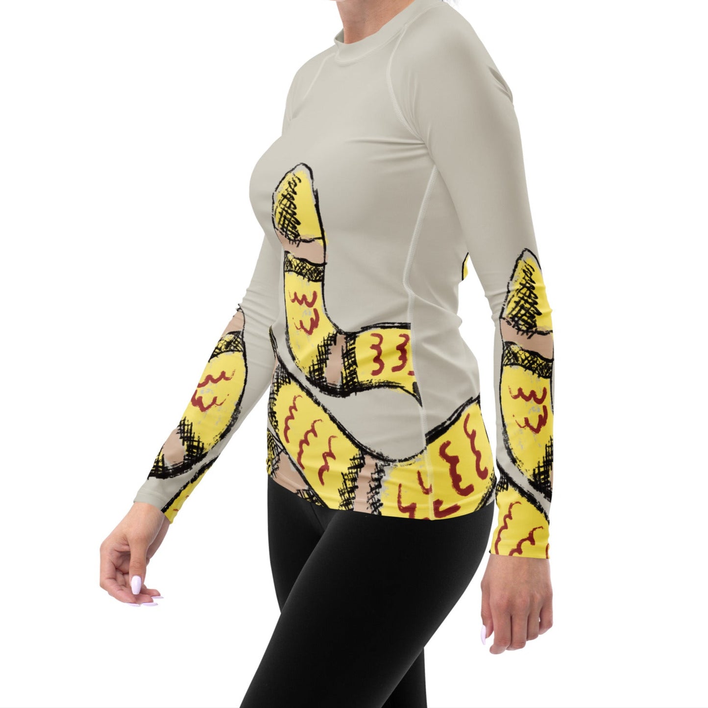 Side view of model in fitted snake print rash guard, showing comfort stretch and vibrant beach-ready style.