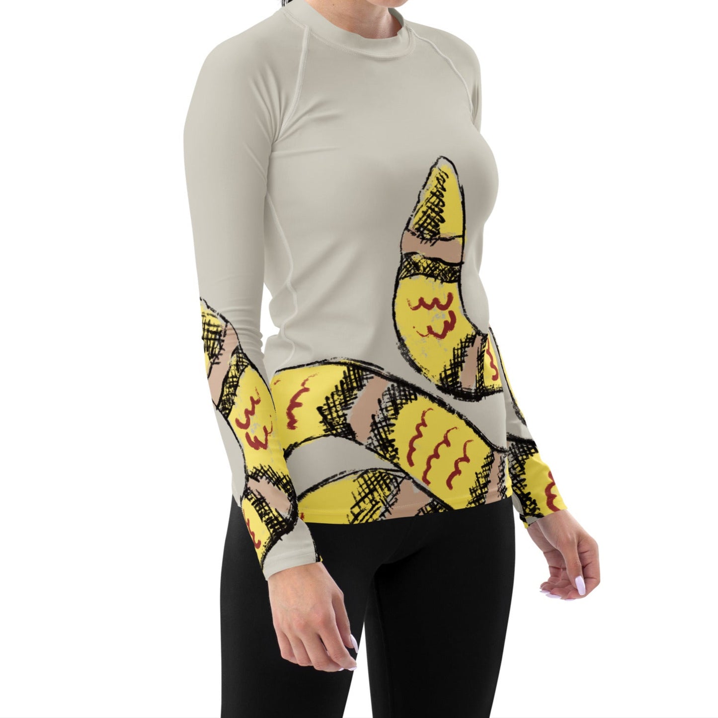 Woman wearing yellow snake print long-sleeve rash guard by Panther & Palm, showcasing UPF 50+ activewear with ergonomic fit.
