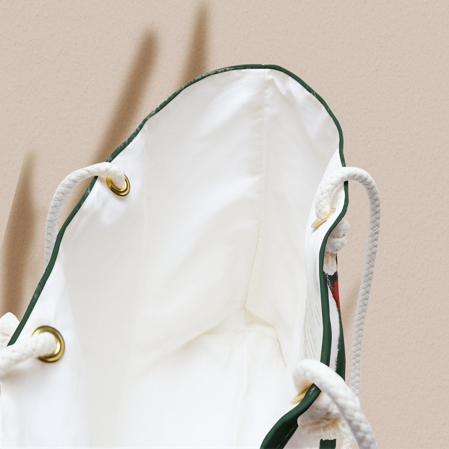 Close-up of the interior of the Snake Stripe Weekender Bag, highlighting the spacious cream lining and durable rope handles with gold-tone accents.