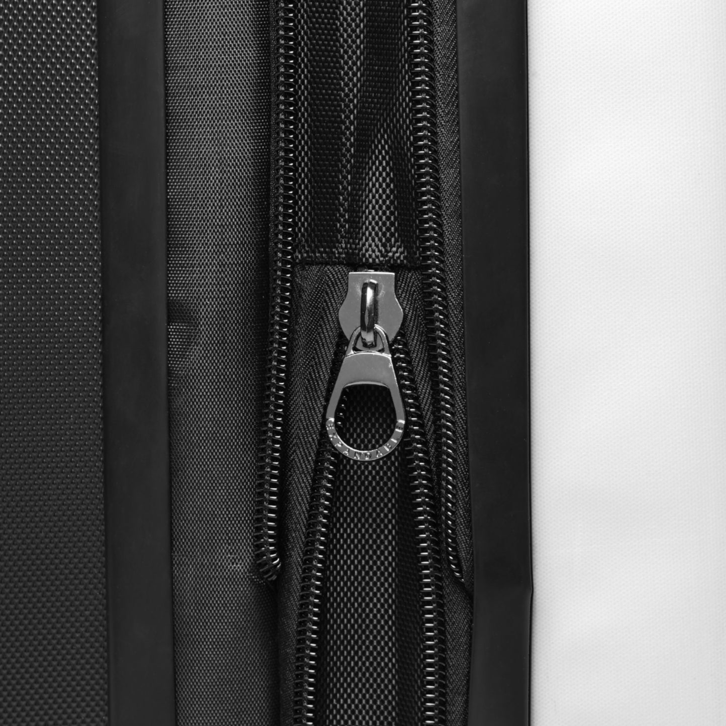 Close-up of suitcase exterior showing expandable storage compartment for extra space.