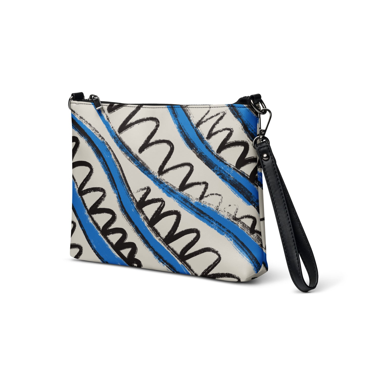Blue and white tropical stripe crossbody bag in vegan leather with black wrist strap and zip closure.