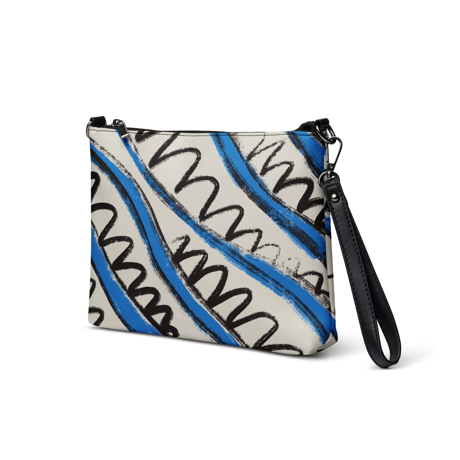 Blue and white tropical stripe crossbody bag in vegan leather with black wrist strap and zip closure.