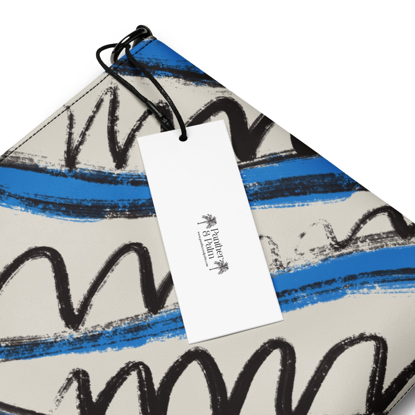  Panther & Palm branded tag on a blue and black wave print vegan leather bag.