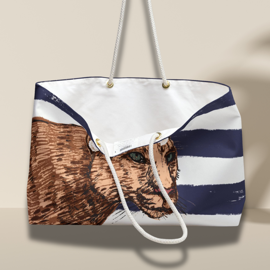 Interior view of the Blue Stripe Lion Print Resort Weekender Bag, showing white lining, gold-tone grommets, and rope handles.