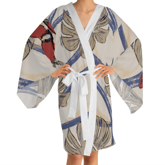 Model facing forward in tropical snake and monstera print kimono robe, featuring wide bell sleeves and white satin collar and belt.