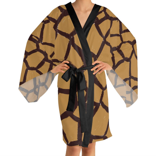 Model wearing the Panther & Palm giraffe robe with black collar and sash, blending editorial animal print with everyday ease.