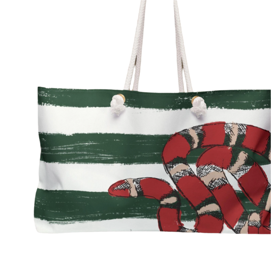 Close up of front view of the Snake Stripe Weekender Bag showcasing bold green and white stripes and the detailed red snake artwork.